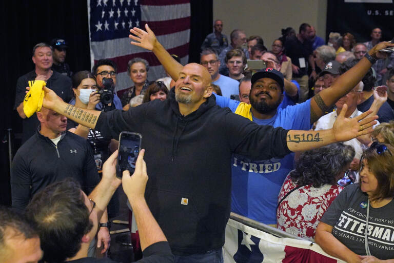 Pennsylvania Lt. Gov. John Fetterman, the Democratic nominee for the state's U.S. Senate seat, center, poses for a photo with supporters after speaking at a rally in Erie, Pa., on Friday, Aug. 12, 2022. (AP Photo/Gene J. Puskar)