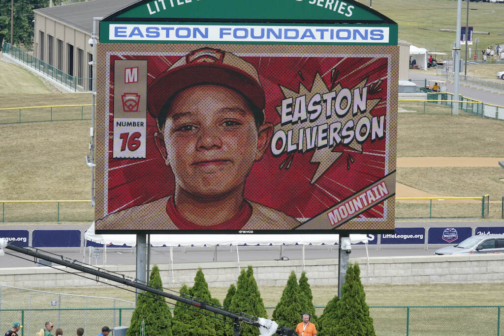 File photo: A picture of Mountain Region Champion Little League team member Easton Oliverson, from Santa Clara, Utah, is shown on the scoreboard at Volunteer Stadium during the opening ceremony of the 2022 Little League World Series baseball tournament in South Williamsport, Pa., Wednesday, Aug 17, 2022. Oliverson was injured when he fell out of a bunk bed at the dormitory complex. (AP Photo/Gene J. Puskar)