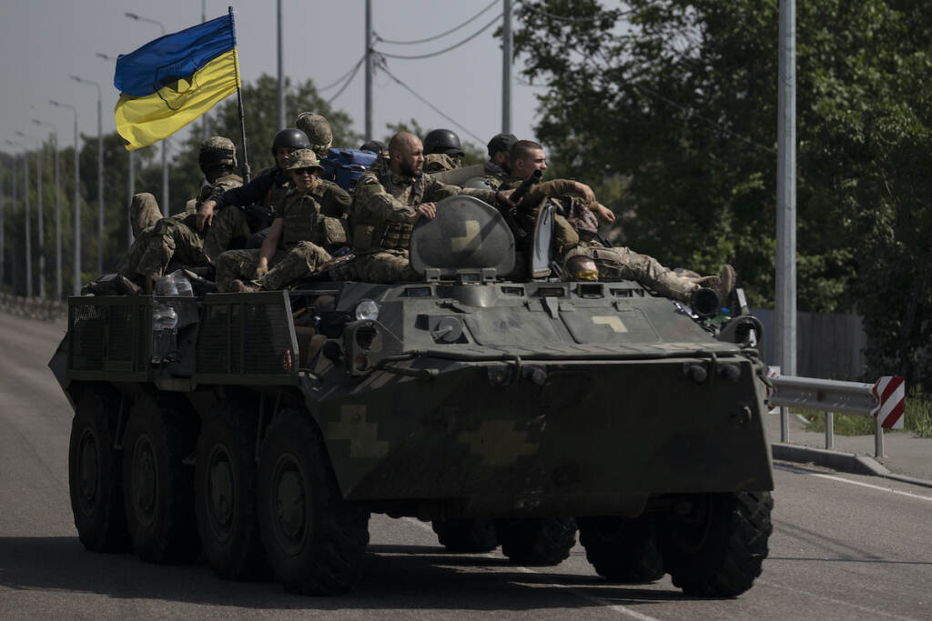 Russia Ukraine War Ukrainian servicemen ride atop of an armored vehicle on a road in Donetsk region, eastern Ukraine, Sunday, Aug. 28, 2022. (AP Photo/Leo Correa)