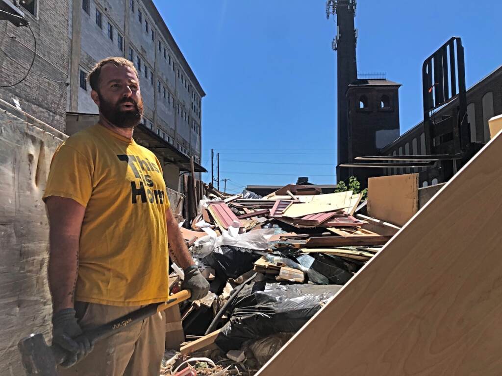 Image from iOS (88) (1) Greg Trainor, executive director of Philly Reclaim, was chopping up scraps as they cleared out the warehouse in its final days. (Emily Rizzo / WHYY)