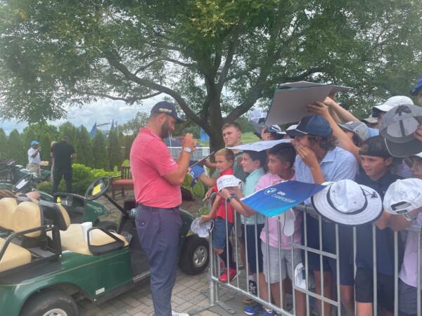 PGA star John Rahm signs autographs for adoring fans