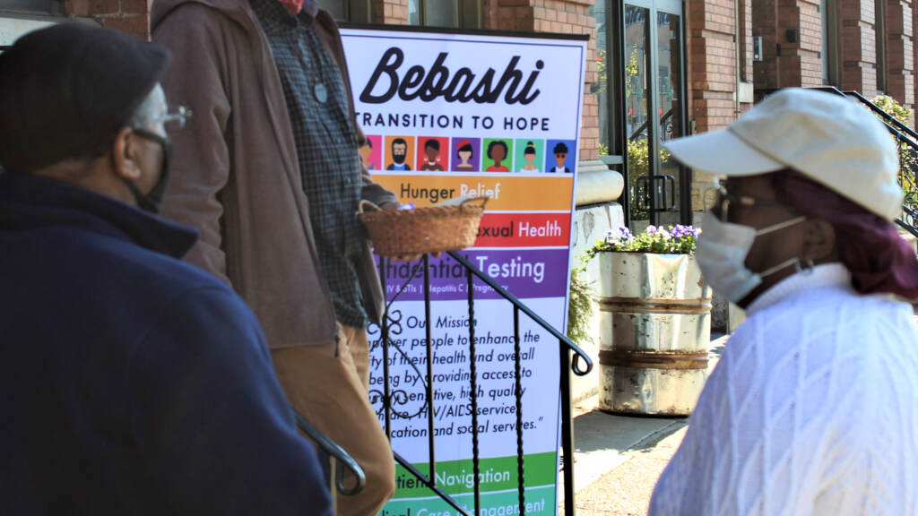 babashi-sign People stand in front of a sign that reads Bebashi.