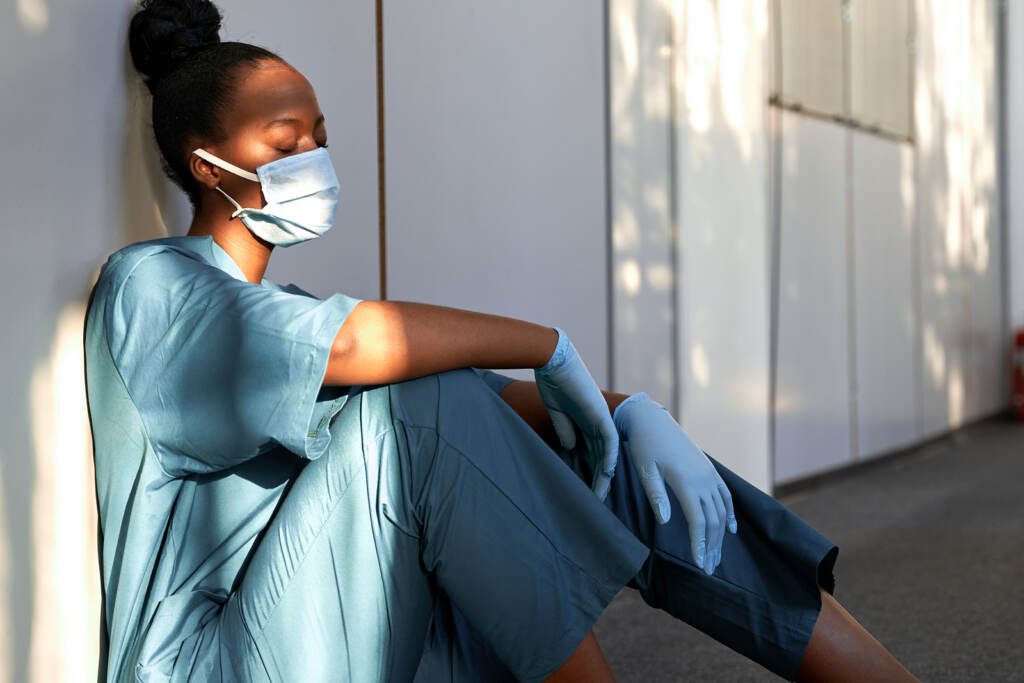 Tired Exhausted Female African Scrub Nurse Wears Face Mask Blue Tired exhausted nurse wears face mask blue uniform