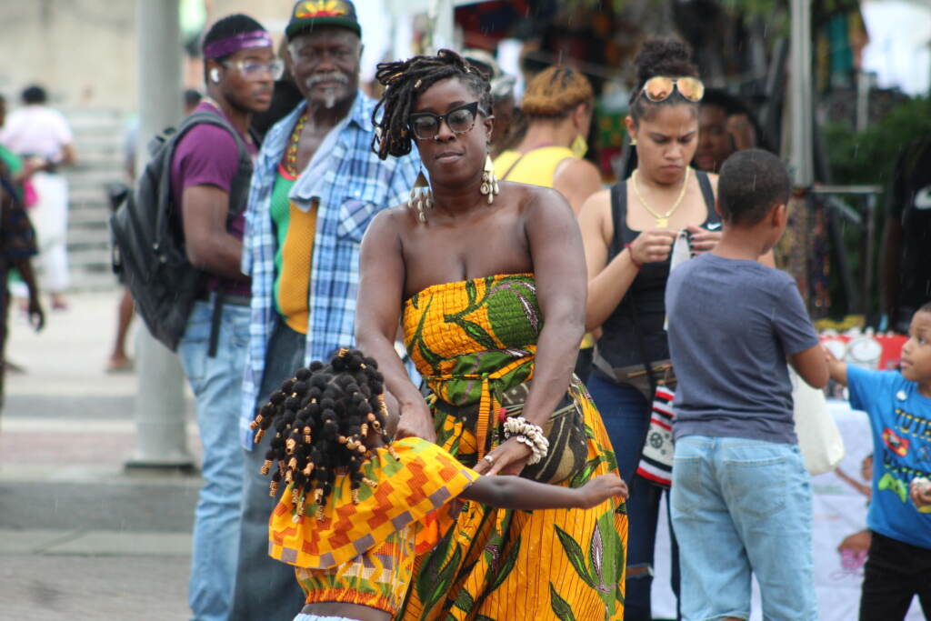caribbean-fest-aug-21-philly-4 People dance at the Caribbean Fest in Philadelphia as others are visible in the background looking on.