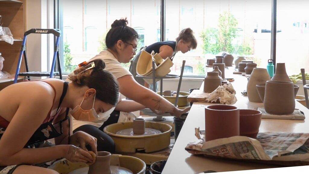 People practice wheelthrowing at the Clay Studio's new facility on North American Street. (WHYY Youth Journalism Camp students)