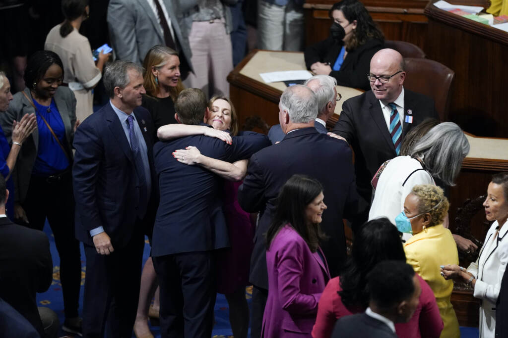 Members of the House of Representatives gather in the chamber to celebrate after the vote to approve the Inflation Reduction Act at the Capitol in Washington, Friday, Aug. 12, 2022. A divided Congress gave final approval Friday to Democrats' flagship climate and health care bill. The House used a party-line 220-207 vote to pass the legislation. (AP Photo/Patrick Semansky)
