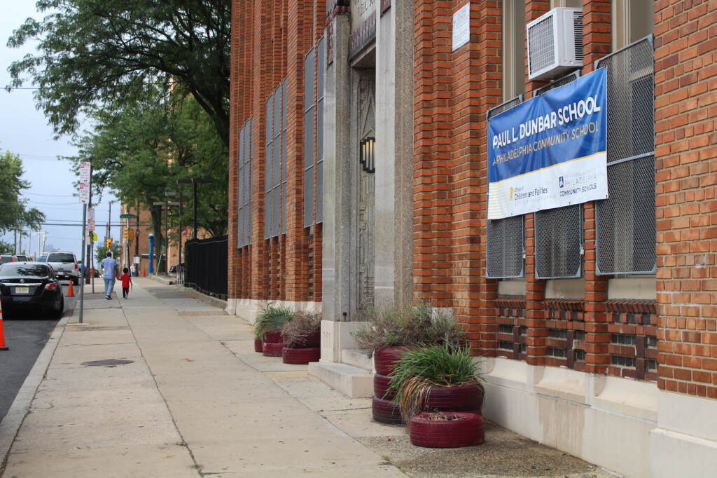 early-dismissal-high-heat-philly-schools A sidewalk on the side of a red-brick school building.