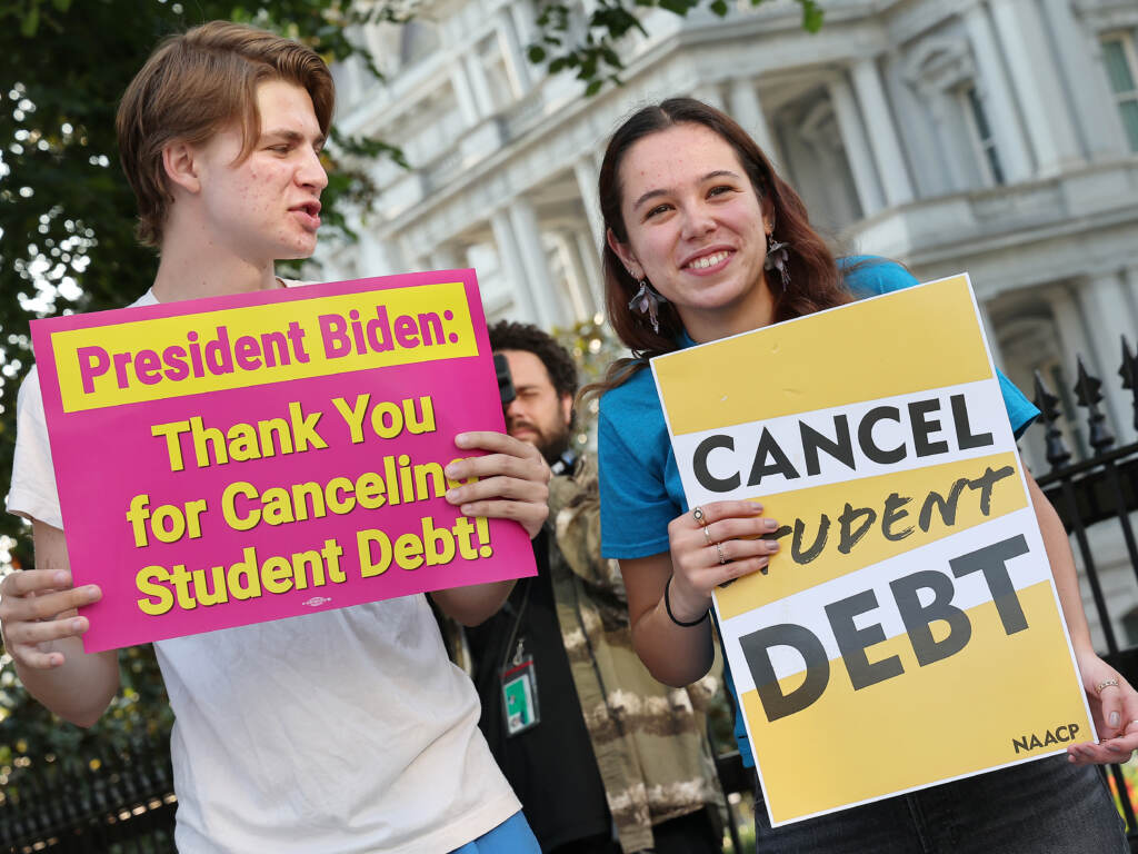 Student loan borrowers stage a rally in front of The White House on Aug. 25 to celebrate President Biden cancelling student debt. The plan has sparked heated debate, including about its economic fairness. Student loan borrowers stage a rally in front of The White House on Aug. 25 to celebrate President Biden cancelling student debt. The plan has sparked heated debate, including about its economic fairness. (Paul Morigi/Getty Images for We the 45m)