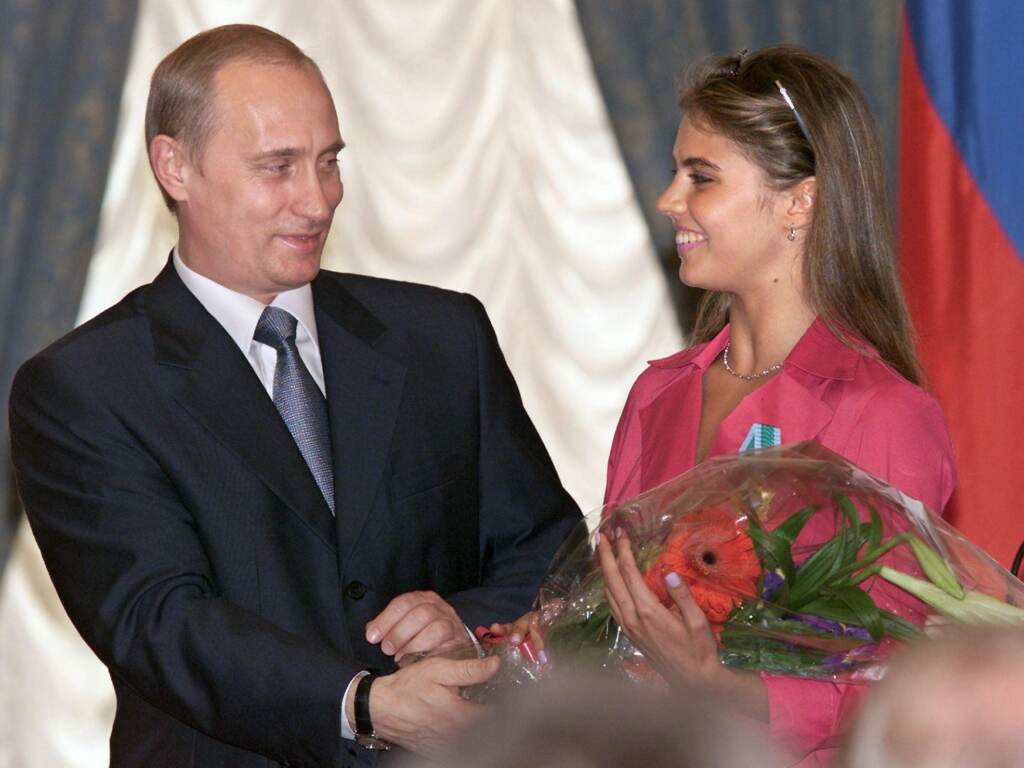 Russian President Vladimir Putin hands flowers to Alina Kabaeva after awarding her with an Order of Friendship during a ceremony at the Kremlin in June 2001. Russian President Vladimir Putin hands flowers to Alina Kabaeva after awarding her with an Order of Friendship during a ceremony at the Kremlin in June 2001. (Sergei Chirikov/AFP via Getty Images)