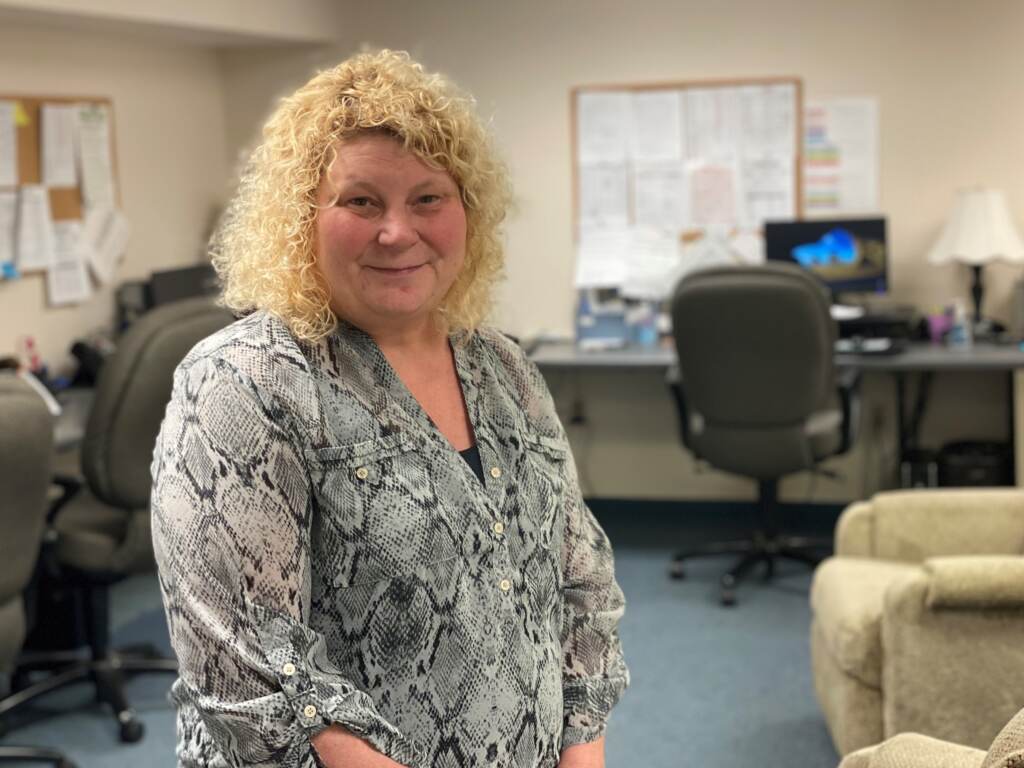 Jayne Wildasin poses for a portrait inside a 988 call center