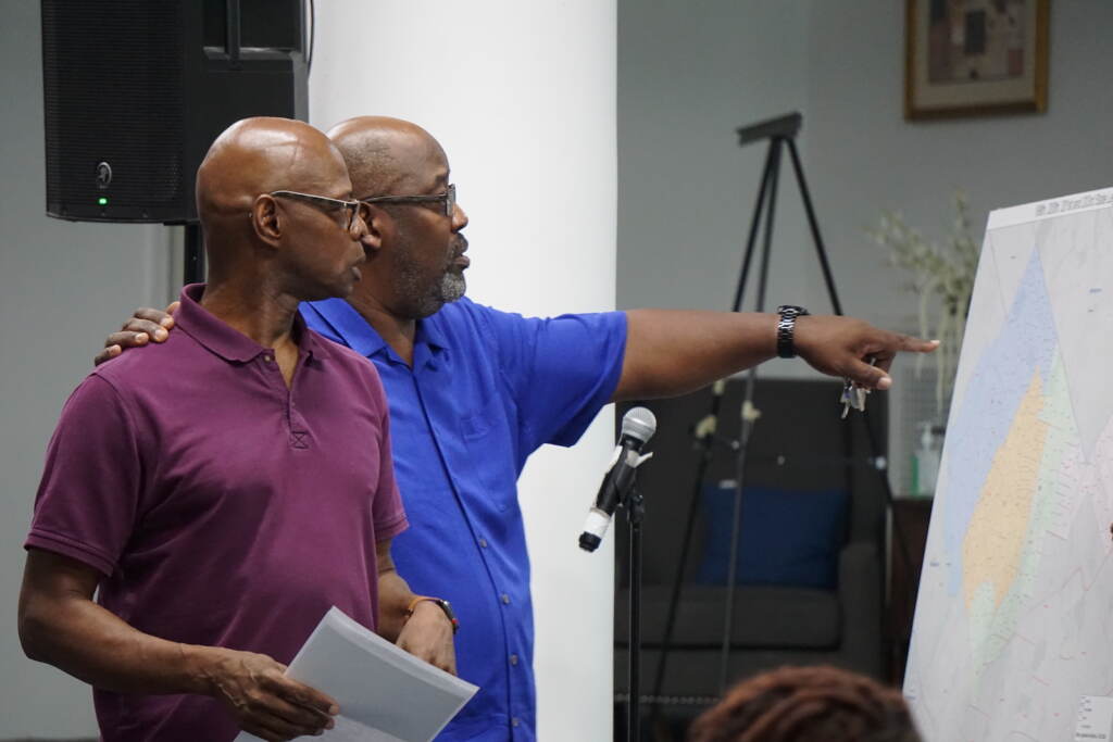 kinsey-gun-violence-meeting-SS-081822-01 State Rep. Stephen Kinsey and Pastor Rob Harrison look over a map of Northwest Philadelphia.
