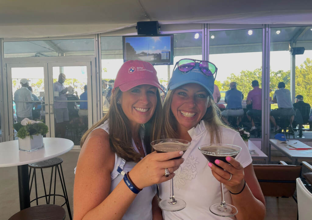 Alison Cohen (left) and Lori Connolly pose for a photo at the PGA tour while holding their drinks