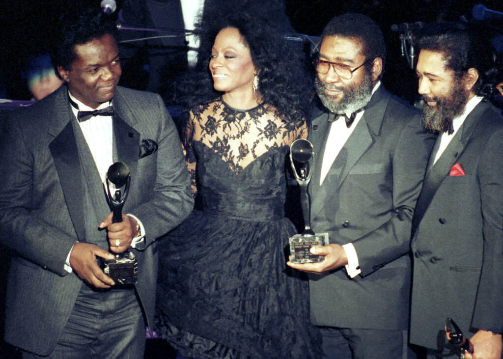 Obit Lamont Dozier FILE - Singer Diana Ross, second from left, joins songwriters, from left, Lamont Dozier, Brian Holland and Eddie Holland after the writing team was inducted into the Rock and Roll Hall of Fame in New York on Jan. 17, 1990. Dozier, of the celebrated Holland-Dozier-Holland team that wrote and produced “You Can’t Hurry Love,” “Heat Wave” and dozens of other hits and helped make Motown an essential record company of the 1960s and beyond, has died at age 81. (AP Photo/Ron Frehm, File)