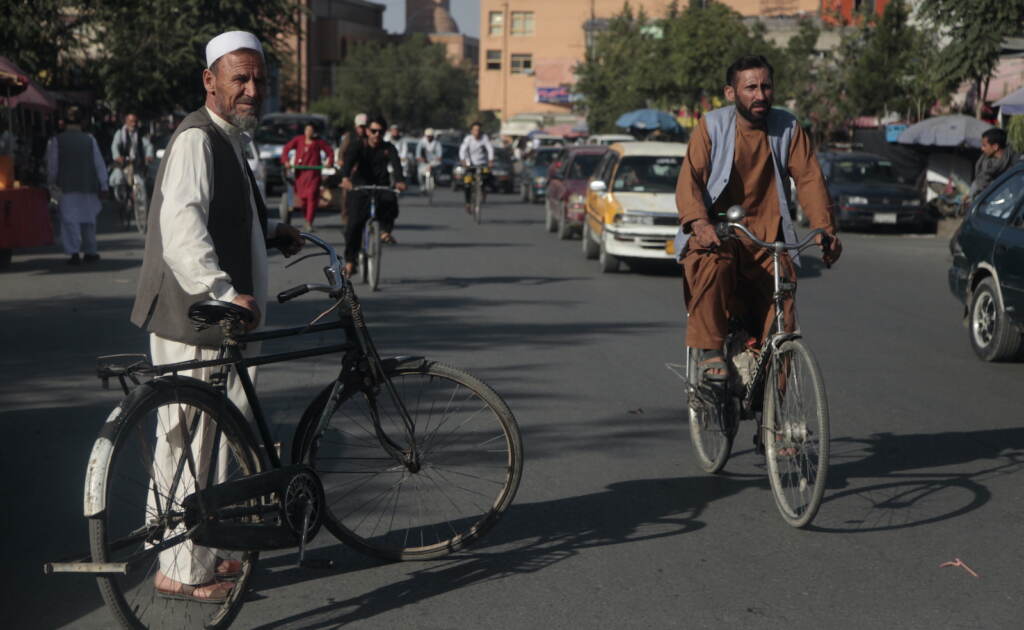 Men ride bicycles in Kabul.