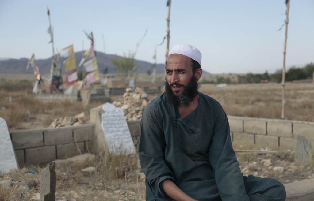 Ahmad Shah sits in the cemetery near his village of Patan Khel