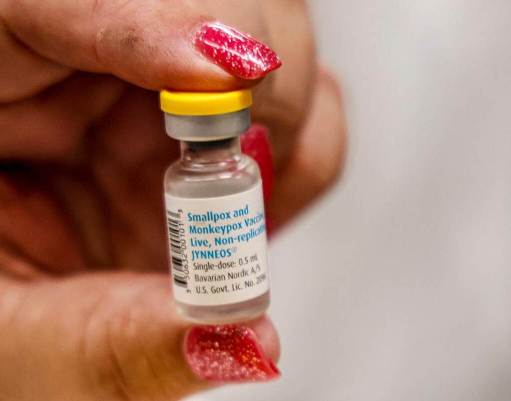 A nurse holds a vial containing the monkeypox vaccine