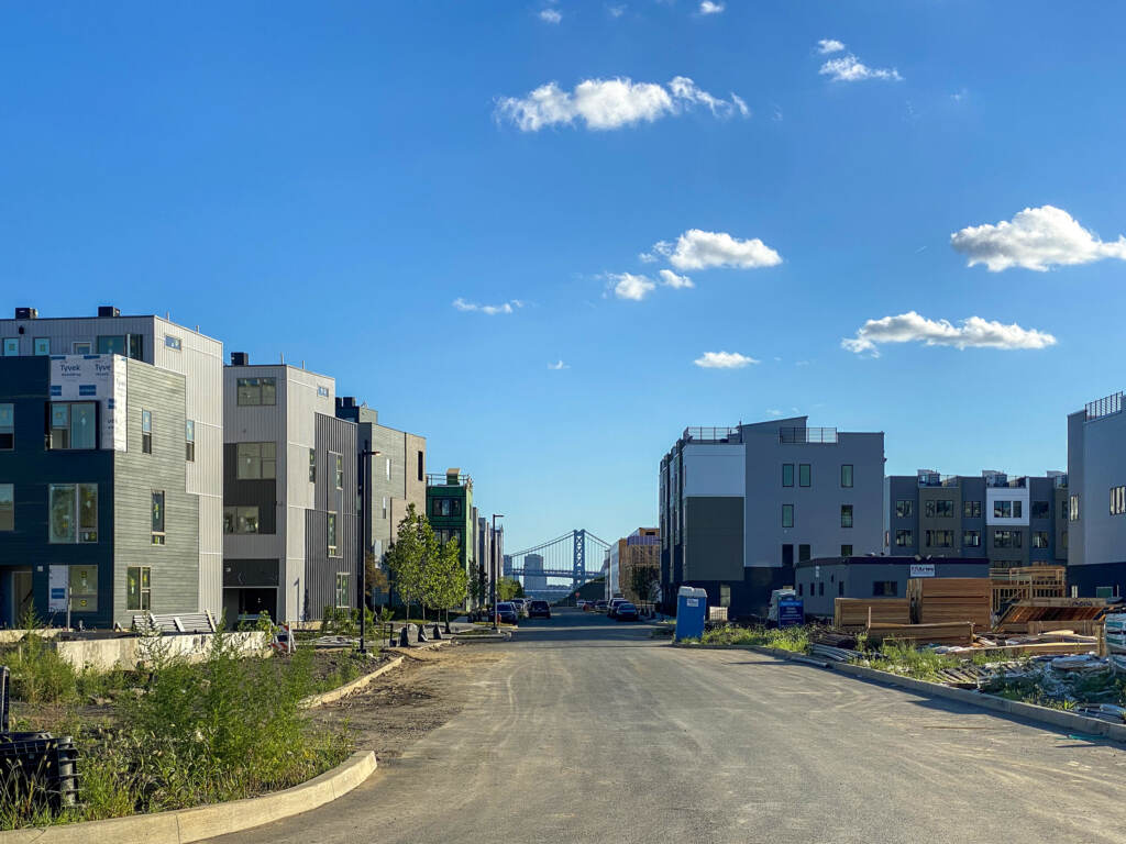 New houses and construction is visible with the Ben Franklin Bridge visible on the horizon.