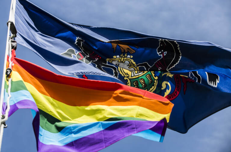 The LGBTQ flag flying alongside Pennsylvania's.