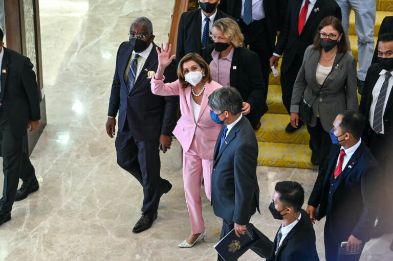 This handout photo taken and released by Malaysia’s Department of Information, U.S. House Speaker Nancy Pelosi, center, waves to media as she tours the parliament house in Kuala Lumpur, Tuesday, Aug. 2, 2022. Pelosi arrived in Malaysia on Tuesday for the second leg of an Asian tour that has been clouded by an expected stop in Taiwan, which would escalate tensions with Beijing. (Malaysia’s Department of Information via AP)