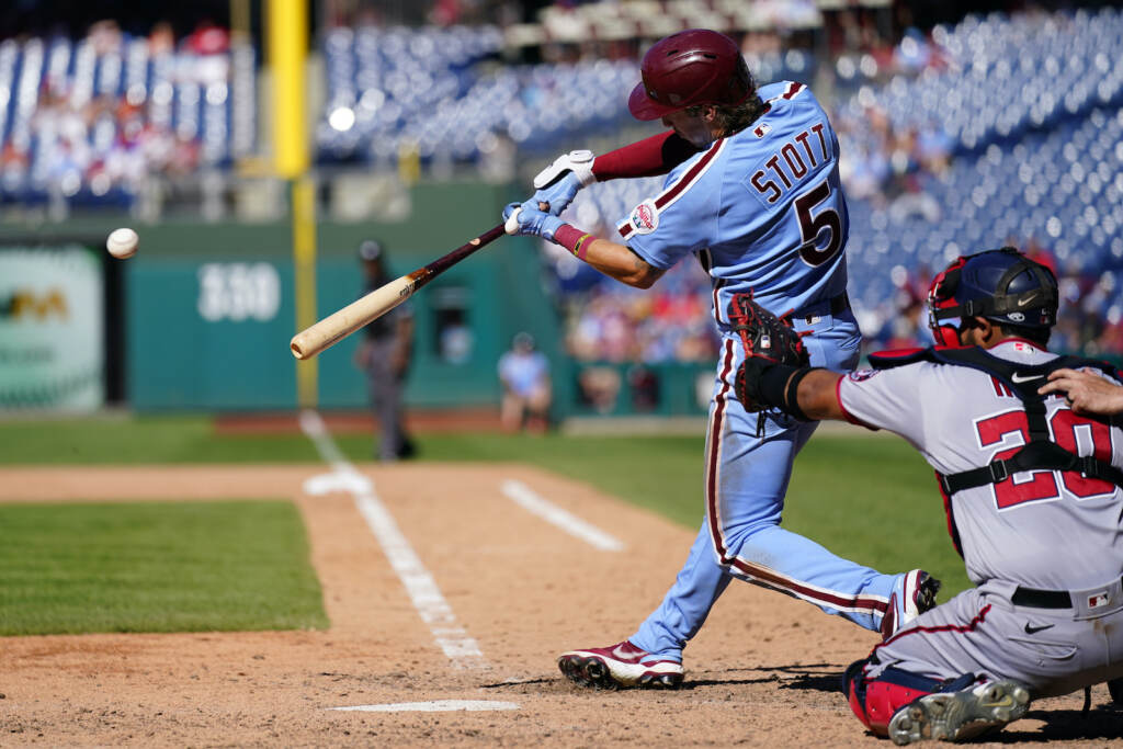 Nationals Phillies Baseball Philadelphia Phillies' Bryson Stott, left, hits a three RBI-double off Washington Nationals' Victor Arano