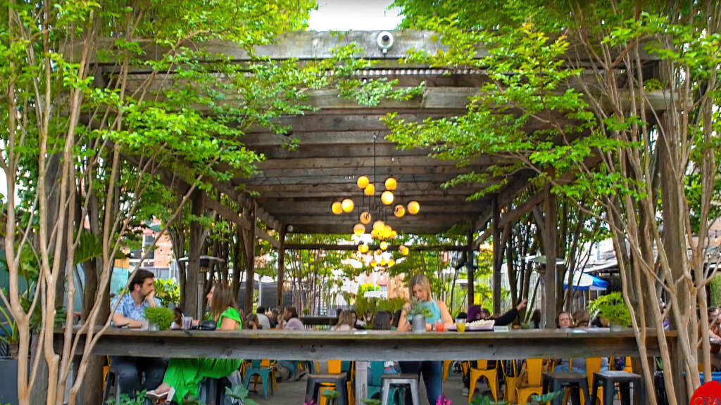 phspopup-beergarden A person sits at a bar in a beer garden.