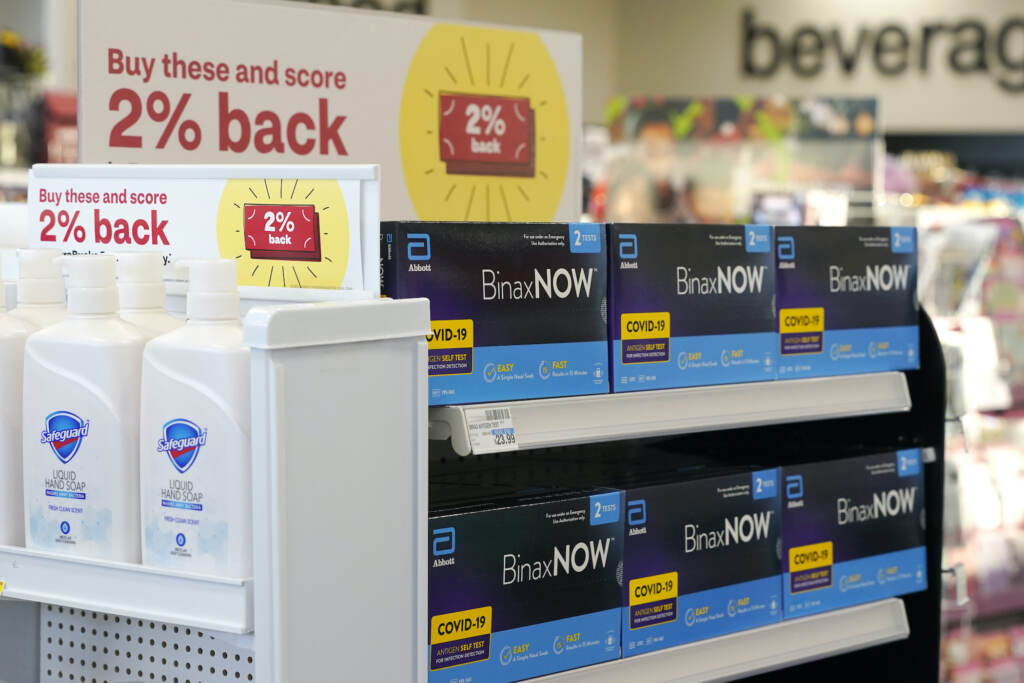 Virus Outbreak Testing FILE - Boxes of BinaxNow home COVID-19 tests made by Abbott displayed for sale next to liquid hand soap at a CVS store in Lakewood, Wash., Monday, Nov. 15, 2021. People screening themselves at home for COVID-19 may need to use three rapid tests to accurately detect the virus, according to new U.S. recommendations released Thursday, Aug. 11, 2022, that call for a longer testing period. (AP Photo/Ted S. Warren, File)