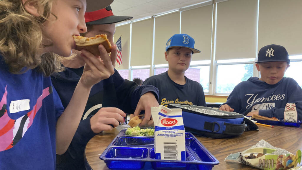 Students eat lunch inside a school