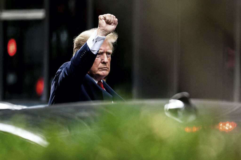 Former President Donald Trump gestures as he departs Trump Tower