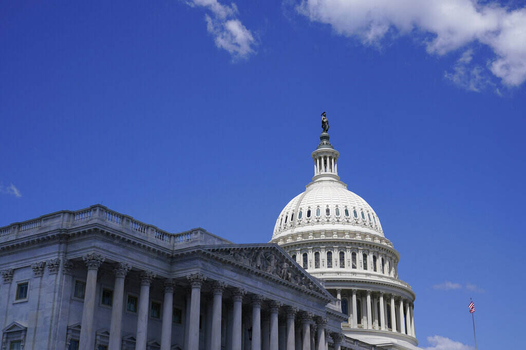 A view from below of the U.S. Capitol Dome and blue skies.