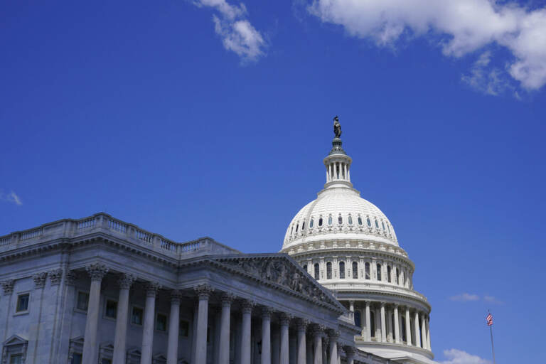 A view from below of the U.S. Capitol Dome and blue skies.