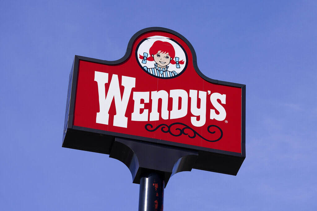 Wendys sign A sign reads Wendys, with a blue sky visible in the background.