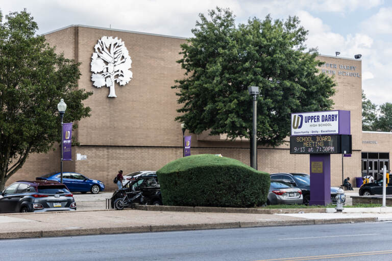 The exterior of Upper Darby High School is visible.