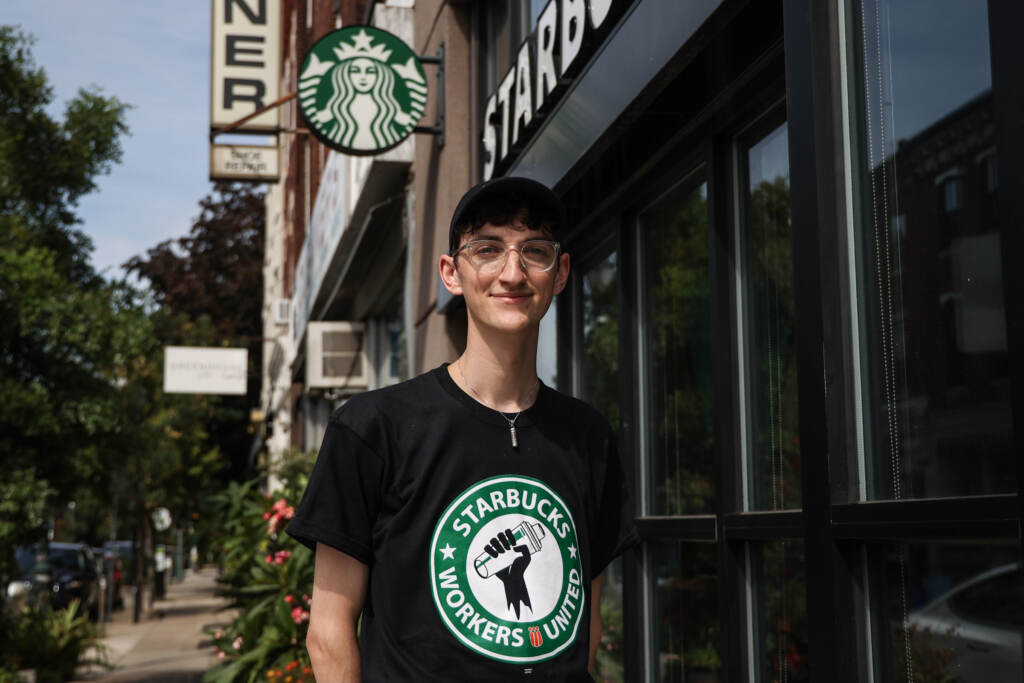 2022 09 05 K PAYNTER LABOR DAY SIP IN STARBUCKs-2 (1) Conor Alguire, a Starbucks barista trainer and union organizer, fighting for worker rights, outside the coffee shop at 22nd and South Street on Labor Day, September 5, 2022. (Kimberly Paynter/WHYY)