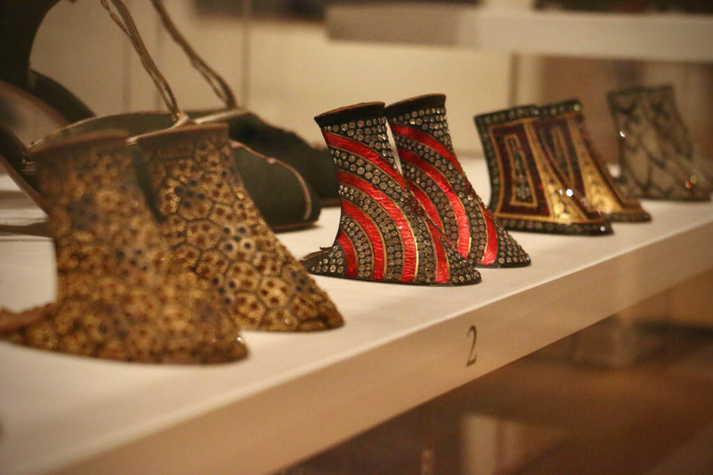 A row of decorative heels, without the rest of the shoe, are displayed.