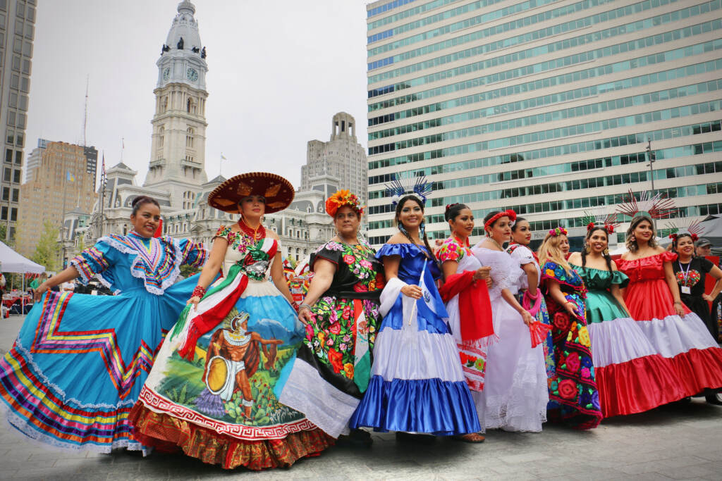 2022 09 30-e lee-philadelphia love park-latin america festival dresses Women in dresses representing Latin American countries pose for photos at the Latin America Thrives in Philadelphia event in Love Park. (Emma Lee/WHYY)