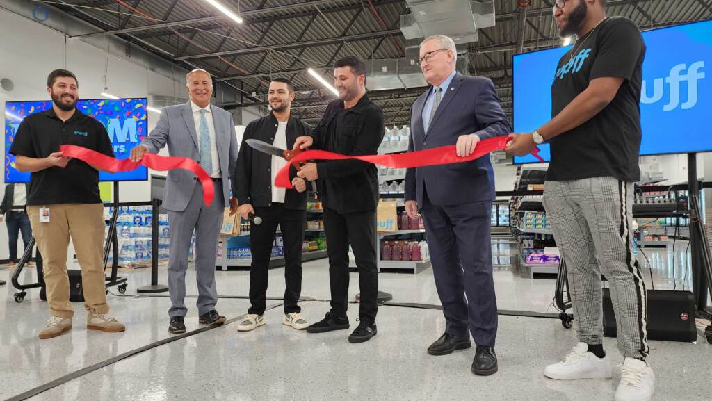 20220920_121701 Gopuff co-founder Rafael Ilishayev cuts the ribbon on a new distribution facility in Spring Garden, alongside (starting second from left) Philadelphia City Councilmember Mark Squilla, Gopuff cofounder Yakir Gola and Philadelphia Mayor Jim Kenney. (Tom MacDonald/WHYY)
