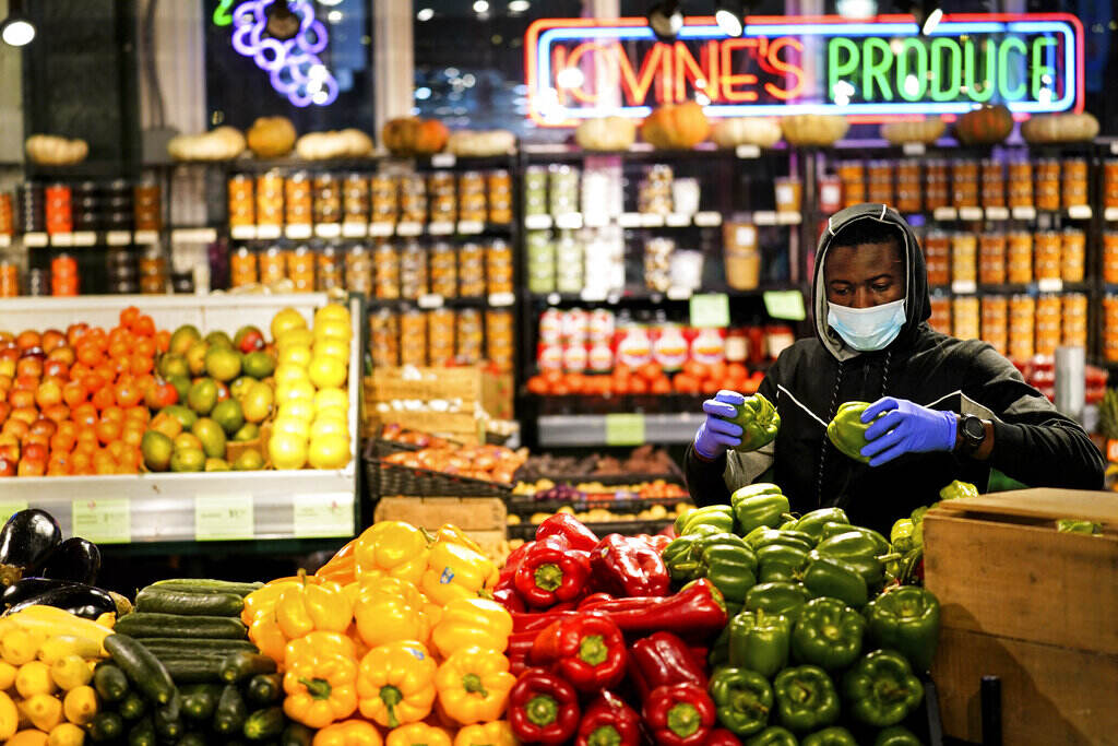 A grocer at the Reading Terminal Market in Philadelphia, Wednesday February 16, 2022 (AP Photo/Matt Rourke)