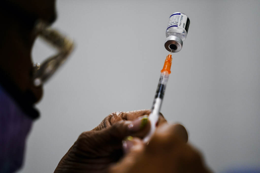 Virus Outbreak Updating Vaccines A syringe is prepared with the Pfizer COVID-19 vaccine