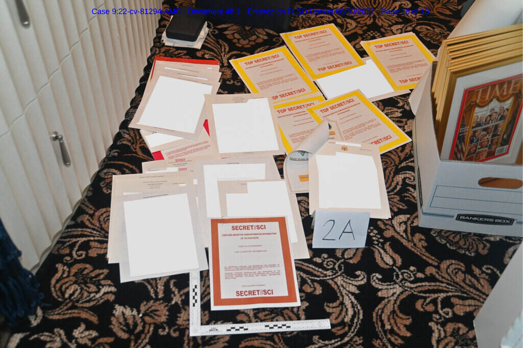 Trump FBI This image contained in a court filing by the Department of Justice on Aug. 30, 2022, and redacted by in part by the FBI, shows a photo of documents seized during the Aug. 8 search by the FBI of former President Donald Trump's Mar-a-Lago estate in Florida. (Department of Justice via AP)