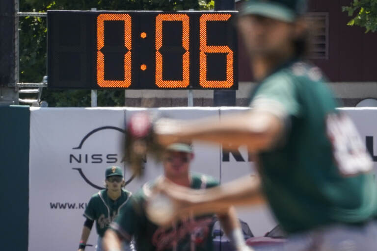 File photo: A pitch clock is deployed to restrict pitcher preparation times during a minor league baseball game between the Brooklyn Cyclones and Greensboro Grasshoppers, July 13, 2022, in the Coney Island neighborhood of the Brooklyn borough of New York. Major League Baseball is set to announce a pitch clock and limits on defensive shifts next season in an effort to shorten games and increase offense. The sport’s 11-man competition committee is set to adopt the rules changes Friday, Sept. 9. (AP Photo/John Minchillo, File)