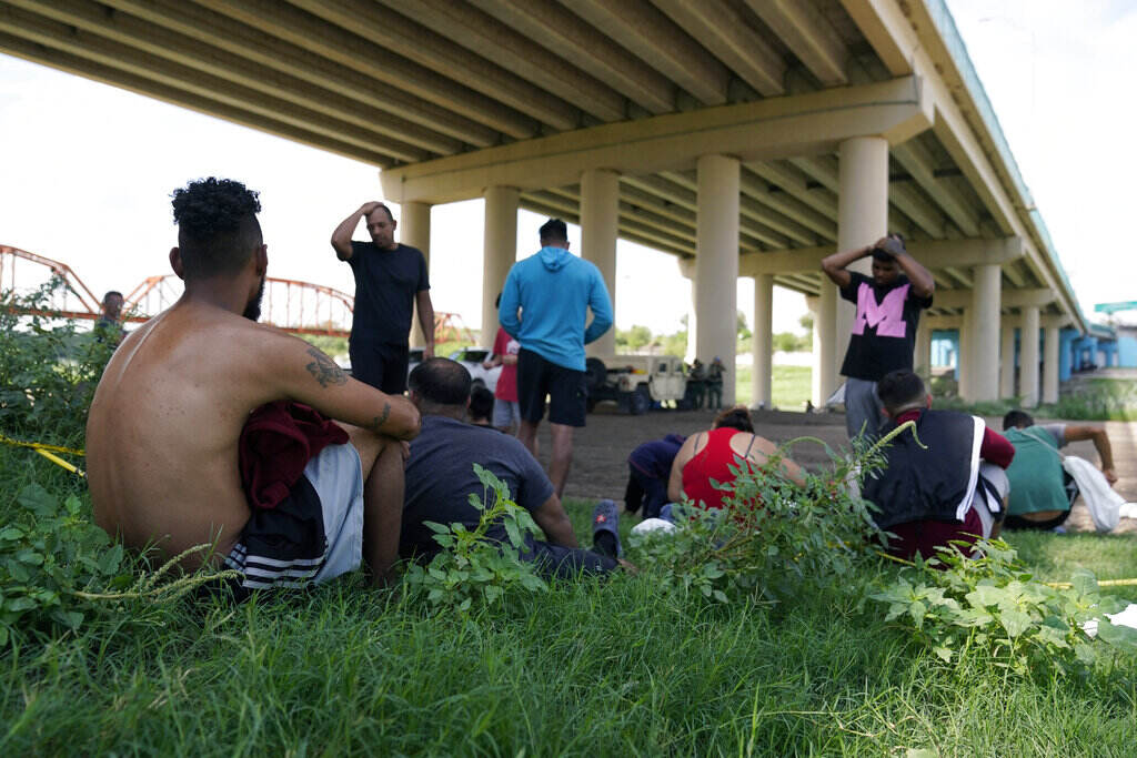 Immigration Venezuelans FILE - Migrants wait to be processed by the Border Patrol after illegally crossing the Rio Grande River from Mexico into the United States at Eagle Pass, Texas, Friday, Aug. 26, 2022. Venezuelans have surpassed Guatemalans and Hondurans to become the second-largest nationality stopped at the U.S. border in August 2022 after Mexicans. (AP Photo/Eric Gay, File)