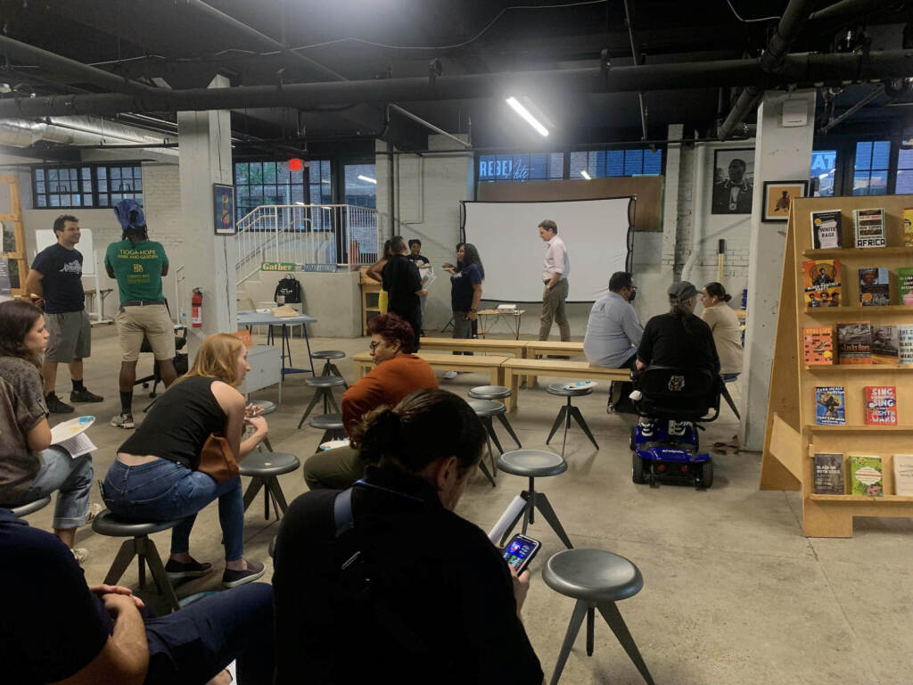 A group of people gather in a room.