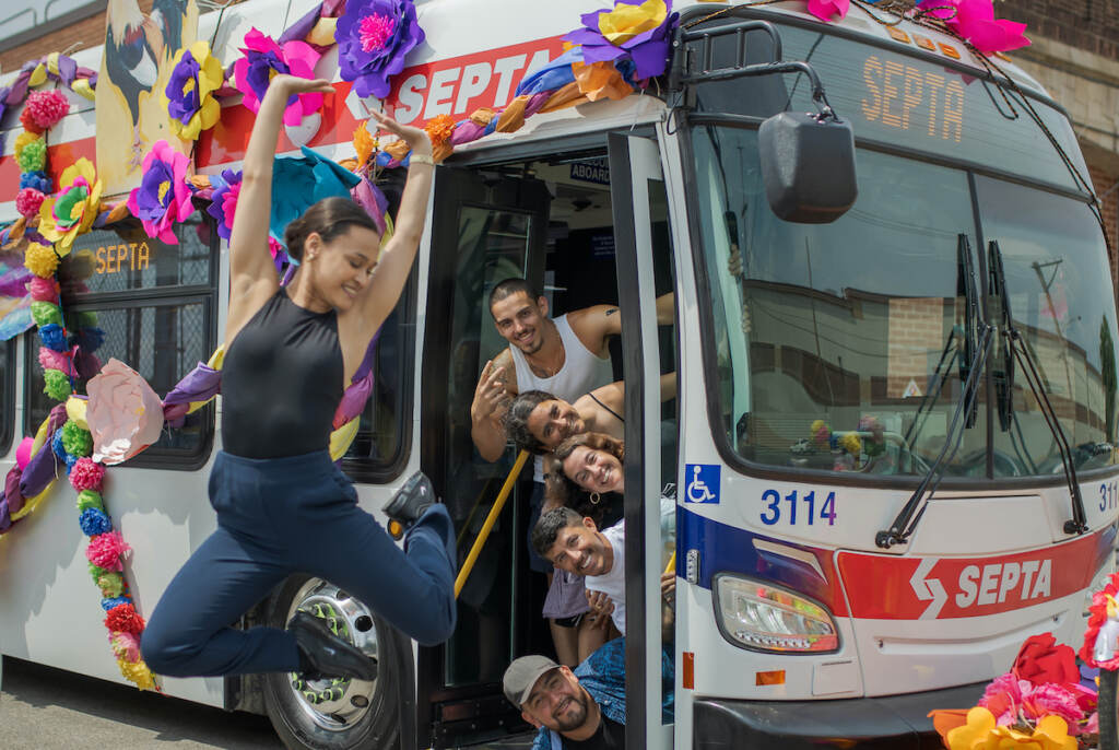 LA GUAGUA STILLS_High Resolution For Printing-256 Dancer Ashley Rivera, who is the protagonist in the film, strikes a pose mid-air. Inside the bus, from top to bottom are the production team: Alaitz Ruiz, Christina Castro-Tauser, Alba Martinez, Martin Alfaro and director, Pedro Escárcega. (Courtesy of Ritmo Lab)