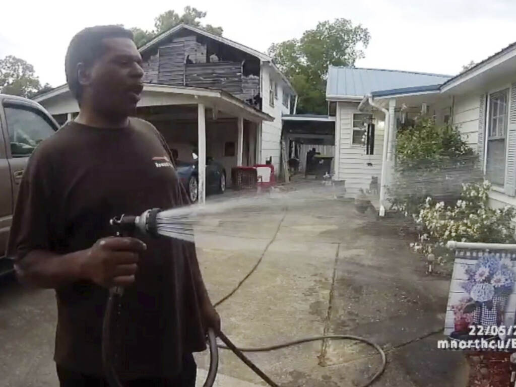 This image captured from bodycam video released by the Childersburg (Ala.) Police Department and provided by attorney Harry Daniels shows Michael Jennings, left, in custody in Childersburg, Ala., on May 22. Jennings was helping out a friend by watering flowers when officers showed up and placed him under arrest within moments. (Childersburg Police Department via AP)