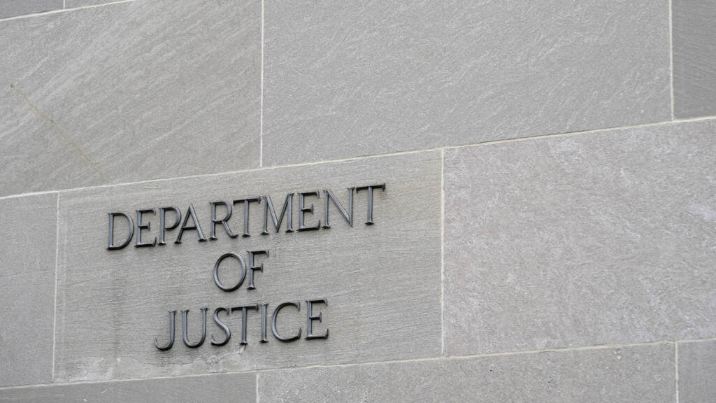 A sign marks the facade of the Department of Justice building in Washington on May 5, 2022. (Patrick Semansky/AP)