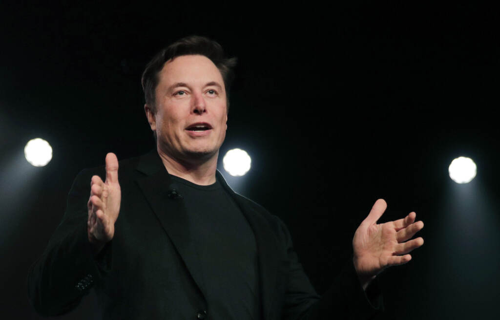 Tesla CEO Elon Musk speaks in March 2019 before unveiling the Model Y at Tesla’s design studio in Hawthorne, Calif.. Musk’s legal team is demanding to hear from a whistleblowing former Twitter executive who could help bolster Musk’s case for backing out of a $44 billion deal to buy the social media company. Elon Musk speaks against a black background