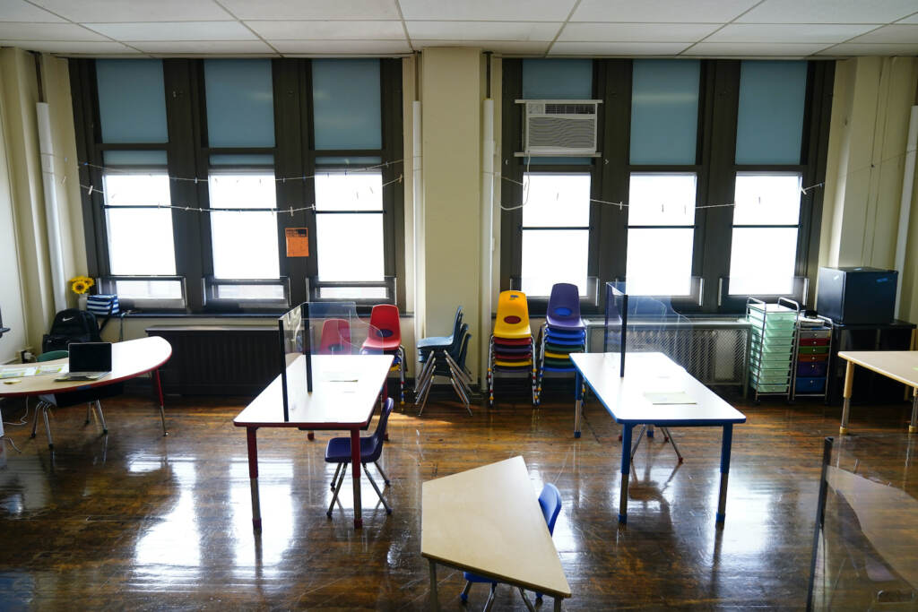 Virus Outbreak Test Scores Desks are spaced apart at an elementary school