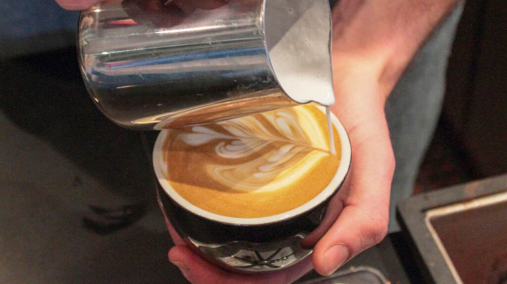 coffee-latte-cappucino-02crop A close-up of a barista making latte art.