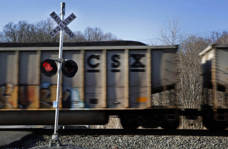 In this March 22, 2014, file photo, a CSX freight train rolls past a grade crossing in Mount Airy, Md. CSX Corp. on Wednesday, Oct. 12, 2016, reported better-than-expected net income in the third quarter even as coal volumes continued double-digit declines. (AP Photo/Patrick Semansky, File)