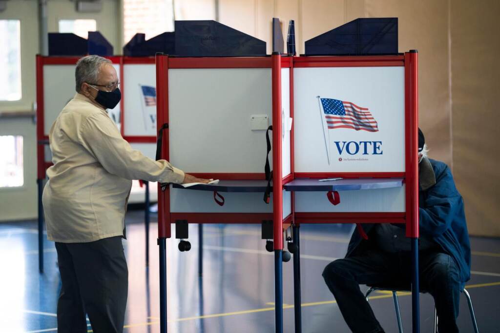 election-ballot-questions People vote at a polling place.